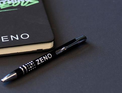 Photo of a notebook and pen on a table.