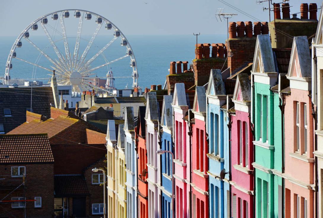 Photo of colourful houses and a ferris wheel.